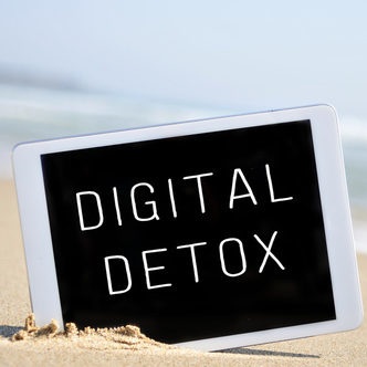 text digital detox in a tablet computer, in the sand of a beach